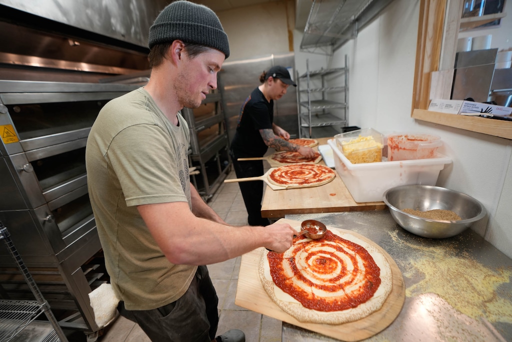 (Francisco Kjolseth | The Salt Lake Tribune) Sam Pew and Nick Garcia assemble 100 pies for Secret Pizza Club pop-up out of Leavity Bread & Coffee on Tuesday, October. 7, 2025.