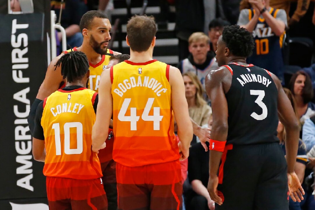 Utah Jazz center Rudy Gobert, rear, is separated from Toronto Raptors forward OG Anunoby (3) in the second half of an NBA basketball game, Monday, March 9, 2020, in Salt Lake City. (AP Photo/Rick Bowmer)
