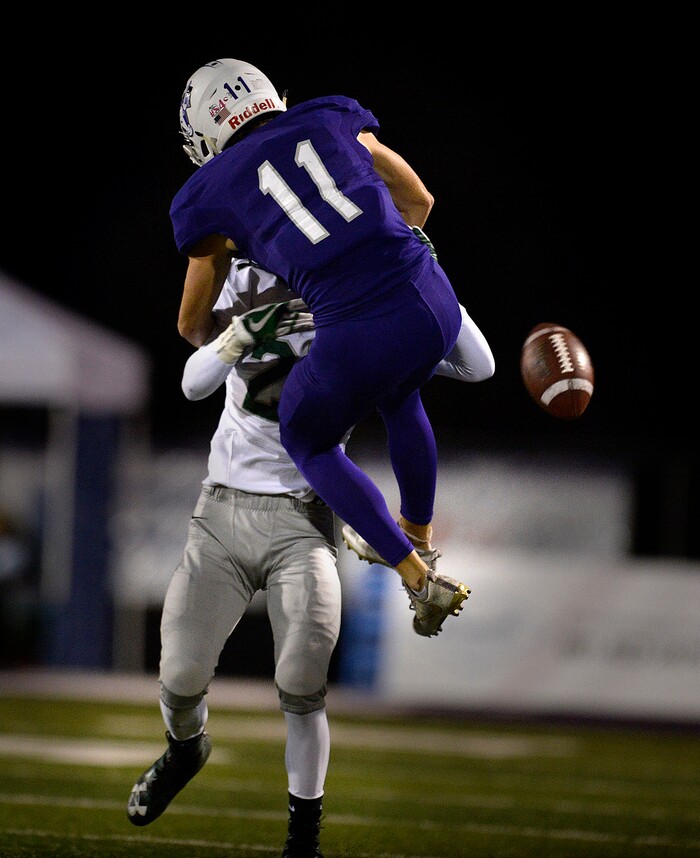 (Scott Sommerdorf   |  The Salt Lake Tribune)   Somehow Olympus DB Jaxon Allred was called for pass interference on this play as Lehi WR Kade Moore jumped into him during first half play. Lehi led Olympus 26-0 late in the second half, Friday, September 22, 2017.