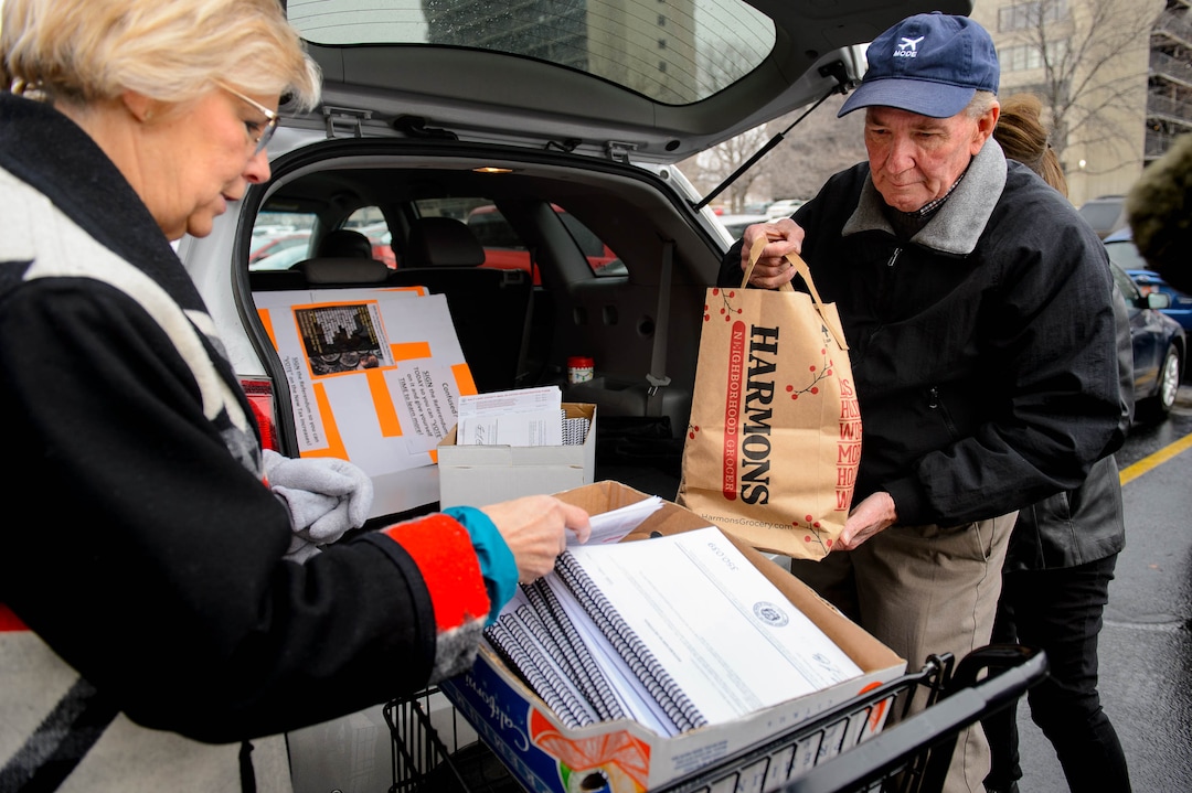 (Trent Nelson  |  The Salt Lake Tribune) Volunteers Claudine Peterson and Kent Jorgenson collect signed tax referendum petitions outside of the Salt Lake County Clerk's Office in Salt Lake City on Tuesday, Jan. 21, 2020.