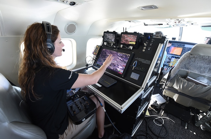 (Francisco Kjolseth  |  Francisco Kjolseth)  Amber Surrency, an aerial research photographer for CoStar Group Inc., documents downtown Salt Lake City on Friday, June 8, 2018, from the air of a specially equipped Cessna Grand Caravan EX. CoStar Group Inc., a research and technology company provides information to commercial real estate professionals, including those in Utah.