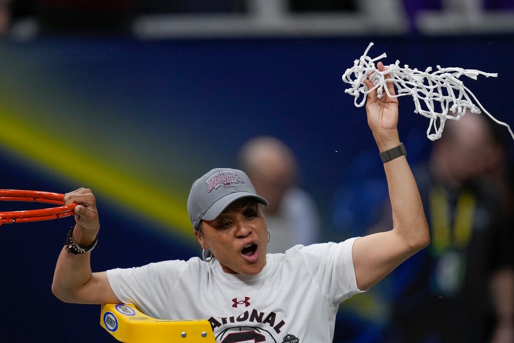 South Carolina head coach Dawn Staley cuts the net after a college basketball game in the final round of the Women's Final Four NCAA tournament against UConn Sunday, April 3, 2022, in Minneapolis. South Carolina won 64-49 to win the championship. Staley pulled her team out of a home-and-home series against BYU over fear of racial slurs being directed toward her players. (AP Photo/Charlie Neibergall)