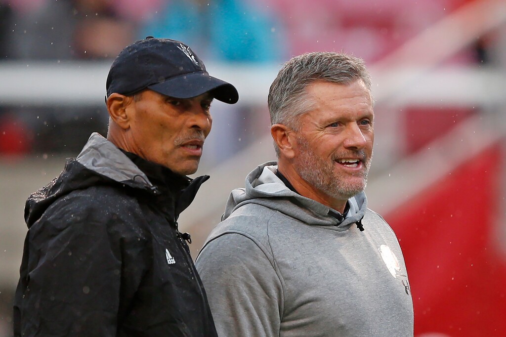(Rick Bowmer | AP) Former Arizona State head coach Herm Edwards, left, and Utah head coach Kyle Whittingham speak before an NCAA college football game Saturday, Oct. 19, 2019, in Salt Lake City.
