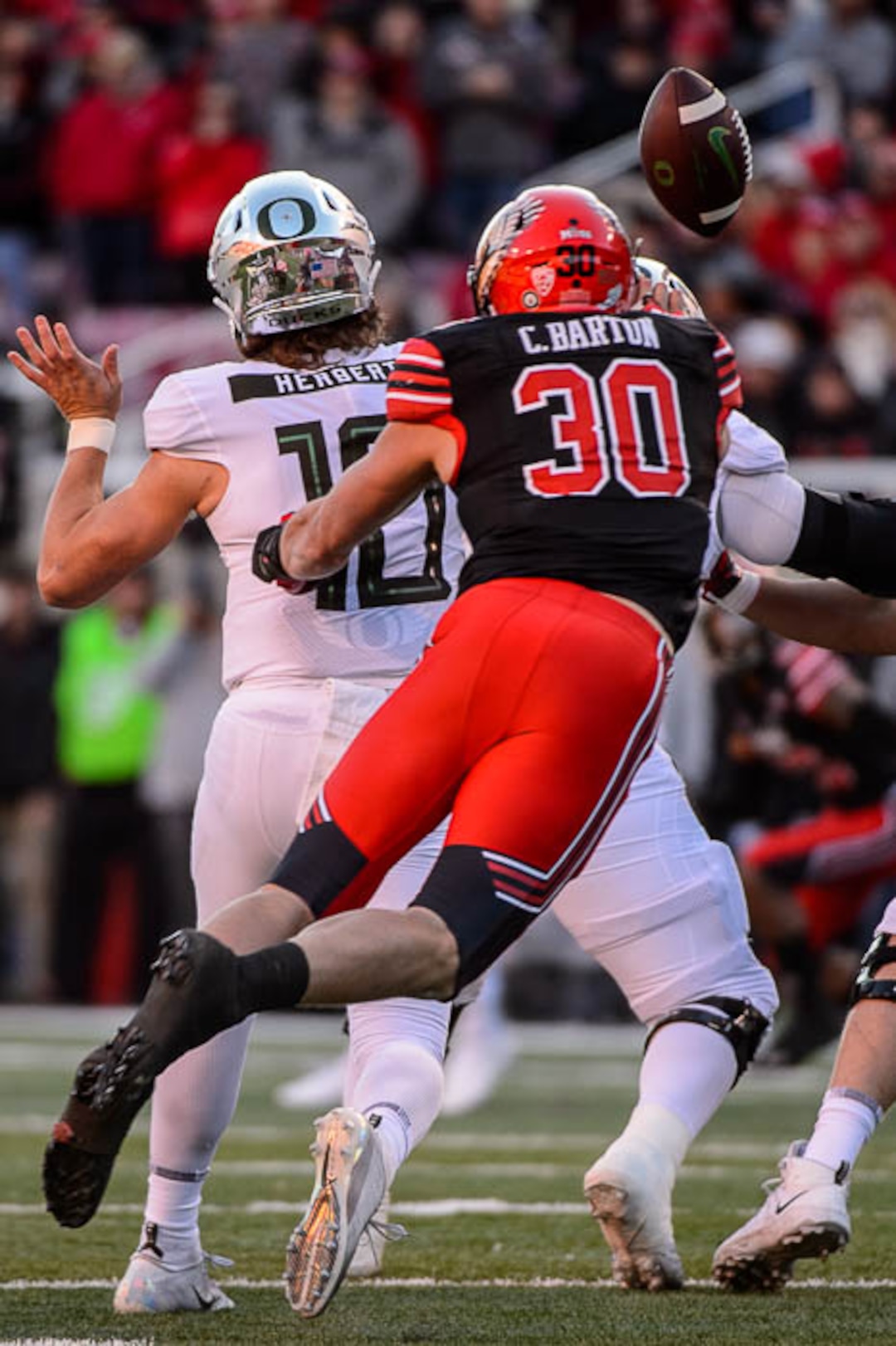 (Trent Nelson | The Salt Lake Tribune)  Utah Utes linebacker Cody Barton (30) knocks the ball from Oregon Ducks quarterback Justin Herbert (10). Utah Utes host the Oregon Ducks, NCAA football at Rice-Eccles Stadium in Salt Lake City on Saturday Nov. 10, 2018.