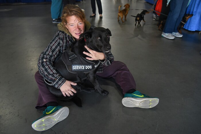 (Francisco Kjolseth  |  The Salt Lake Tribune)  Jennifer Watts holds her service dog Ruby Ray getting vaccinations and micro chipped during Salt Lake CityÕs second annual Project Homeless Connect takes place at the Salt Palace Convention Center on Friday, Oct. 12, 2018, that brings together community volunteers to provide services for individuals and families in need or experiencing homelessness. More than 800 community volunteers and 90 service providers connect those in need with more than 200 services.