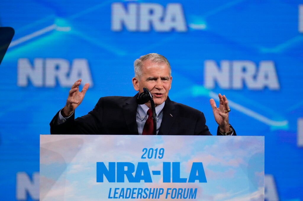 (AP Photo/Michael Conroy) In this Friday, April 26, 2019 photo, National Rifle Association President Col. Oliver North speaks at the National Rifle Association Institute for Legislative Action Leadership Forum in Lucas Oil Stadium in Indianapolis. On Saturday, North announced that he will not serve a second term as the president of the NRA amid inner turmoil in the gun-rights group.