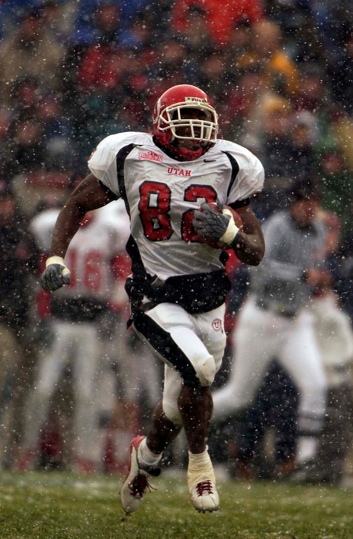 (Trent Nelson  |  Tribune file photo)  Utah's Paris Warren takes the ball upfield in the snow against BYU on Saturday November 22, 2003 at LaVell Edwards Stadium.