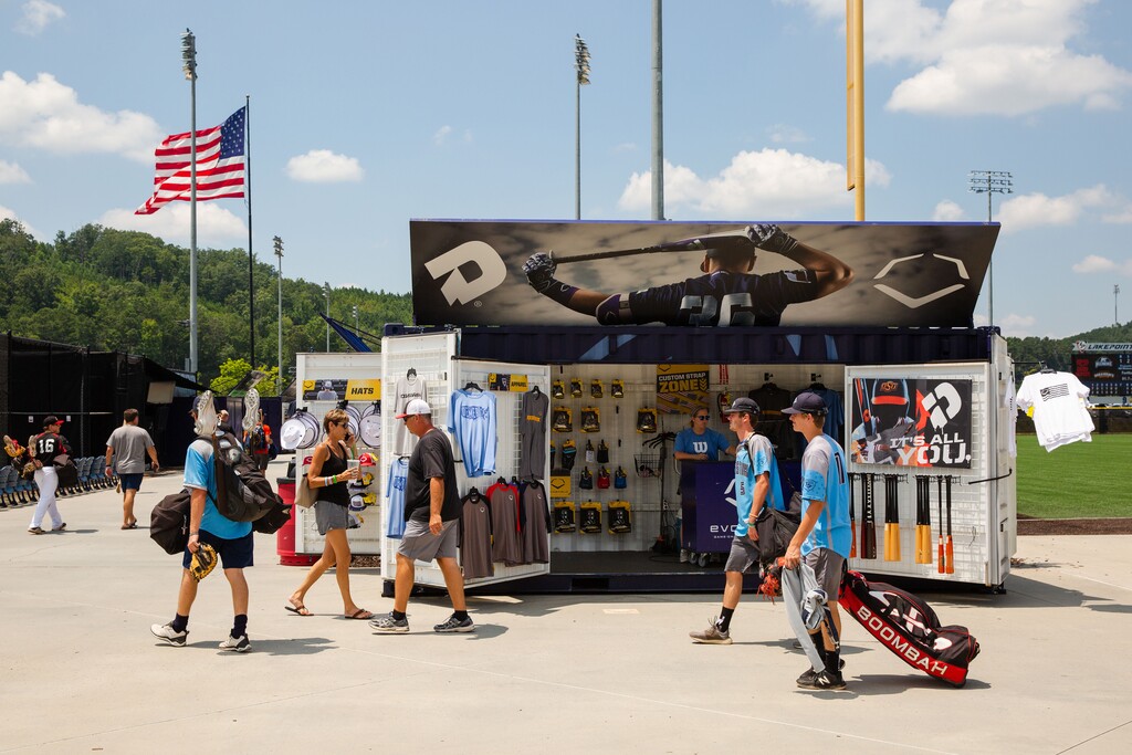 (Kevin D. Liles | The New York Times file photo) People walk through the LakePoint Sporting Community for the Perfect Game World Series in Emerson, Ga., July 25, 2018. Before the spread of the coronavirus, youth sports generated more than $15 billion annually and created the "tourna-cation circuit," as it is known, by becoming like a cruise ship for sporting families with all-inclusive offerings, but now there has been an enormous reckoning, one that has evaporated tens of millions of dollars and is getting worse daily as events and camps are canceled into the summer.