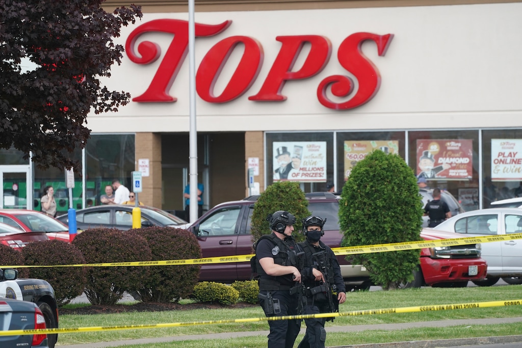 (Derek Gee |The Buffalo News via AP) Police secure an area around a supermarket where several people were killed in a shooting, Saturday, May 14, 2022 in Buffalo, N.Y. Officials said the gunman entered the supermarket with a rifle and opened fire. Investigators believe the man may have been livestreaming the shooting and were looking into whether he had posted a manifesto online