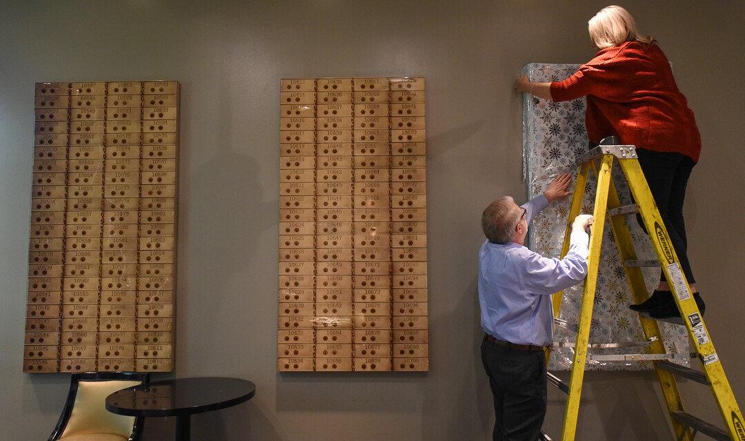 (Francisco Kjolseth  |  The Salt Lake Tribune)  Ric Tanner, the Hotel Monaco's general manager, and Naomi Hall gift-wrap the wall decorations, in anticipation of The Miracle Bar, a Christmas-themed pop-up with holiday drinks and decorations.