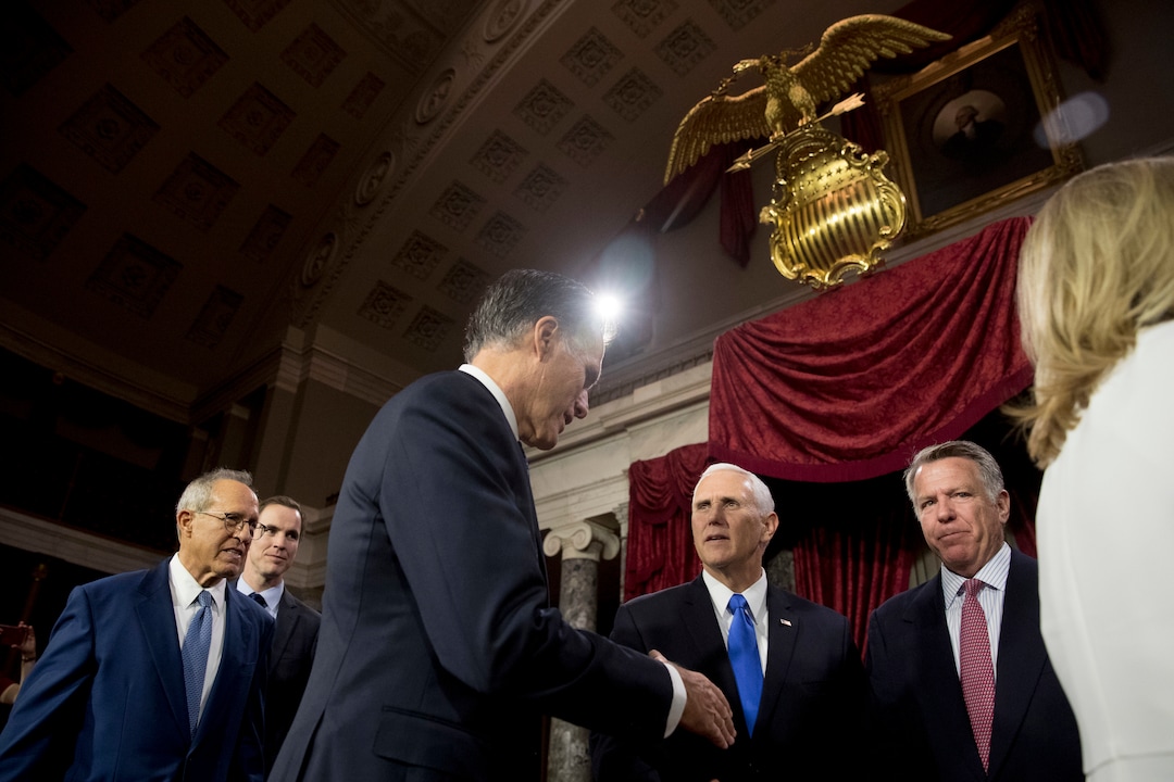 Sen. Mitt Romney, R-Utah, center left, shakes hands with Vice President Mike Pence, center right, following a mock swearing in ceremony in the Old Senate Chamber on Capitol Hill in Washington, Thursday, Jan. 3, 2019, as the 116th Congress begins. (AP Photo/Andrew Harnik)