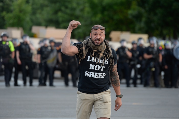 (Francisco Kjolseth  |  The Salt Lake Tribune) Matthew Byrd yells "the violence stops now," as he defuses anger by protesters across from a line of police ready to enforce a mandatory curfew in Salt Lake City on Monday, June 1, 2020.
