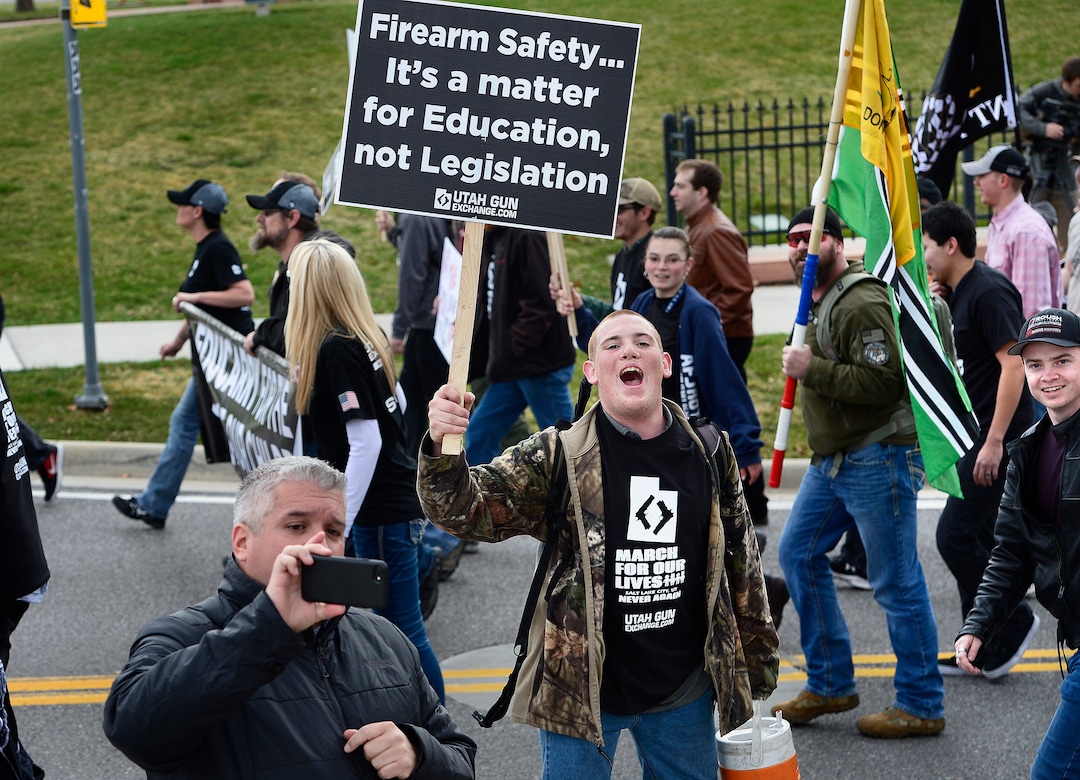 (Scott Sommerdorf | The Salt Lake Tribune) Pro gun "March Before Our lives" marchers shout at members of the media as they march up State Street to the Utah State Capitol building, Saturday, March 24, 2018.