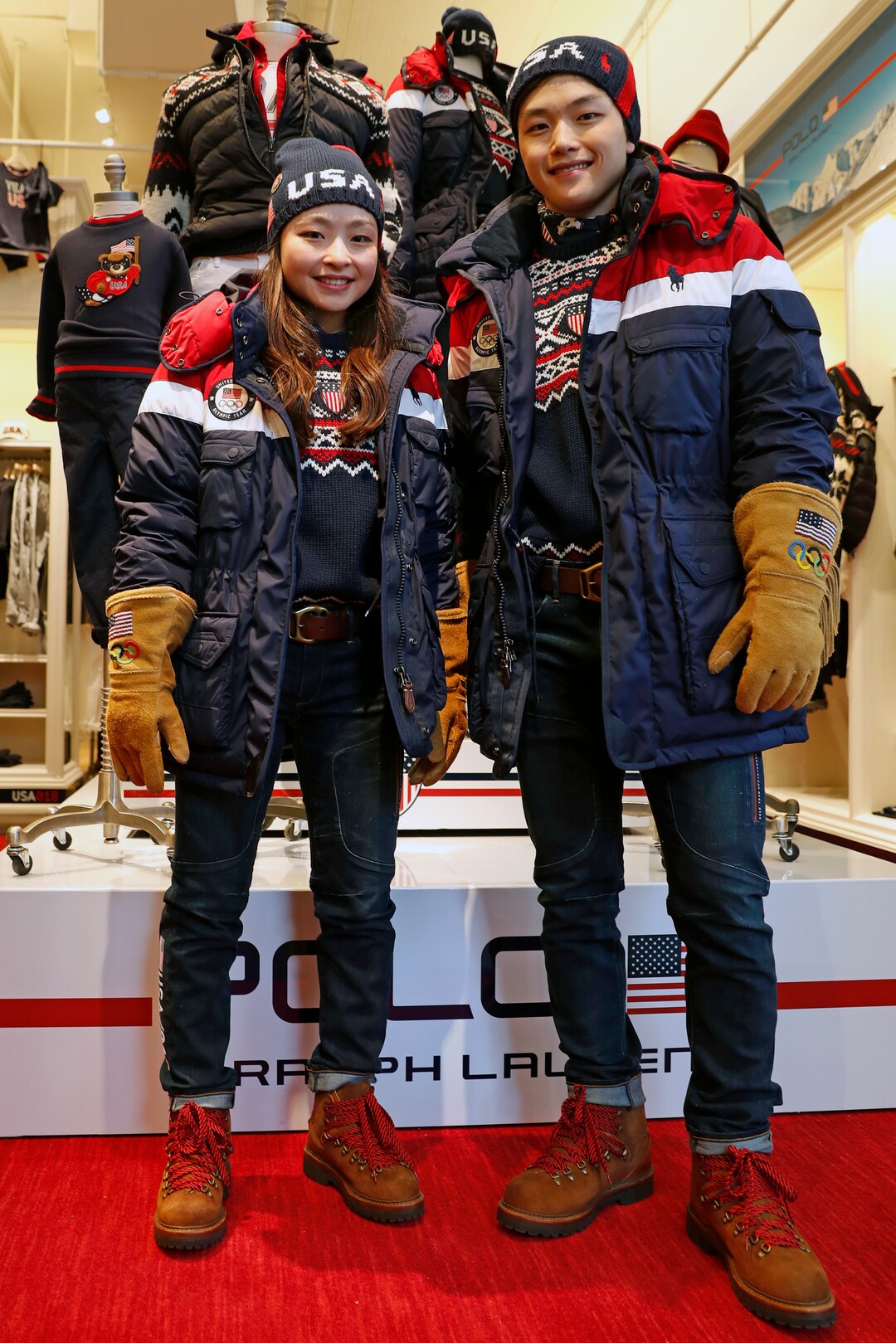 Ice dancing pair Maia Shibutani, left, and Alex Shibutani, a brother and sister team, pose for photographs wearing Team USA Opening Ceremony uniforms designed by David Lauren for Polo Ralph Lauren, Monday, Jan. 22, 2018, outside the brand's Prince Street store in New York. The parkas have a battery-operated, built-in heating element that can be adjusted using a cell phone. The clothing will be worn at the upcoming Winter Olympics in South Korea. (AP Photo/Kathy Willens)