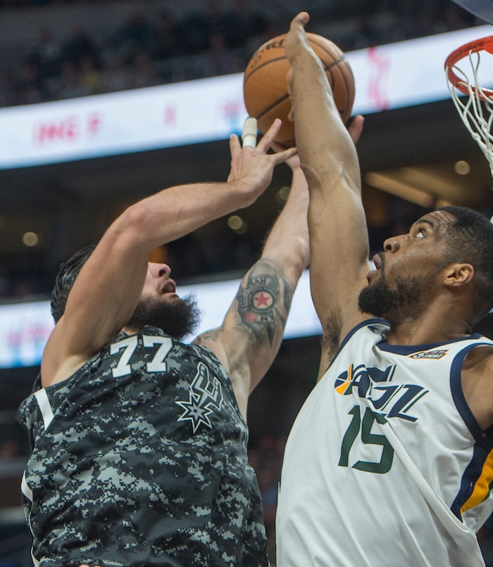 (Rick Egan  |  The Salt Lake Tribune)  San Antonio Spurs center Joffrey Lauvergne (77) shoots as Utah Jazz forward Derrick Favors (15) defends, in NBA action Utah Jazz vs San Antonio Spurs in Salt Lake City, Monday, February 12, 2018.


