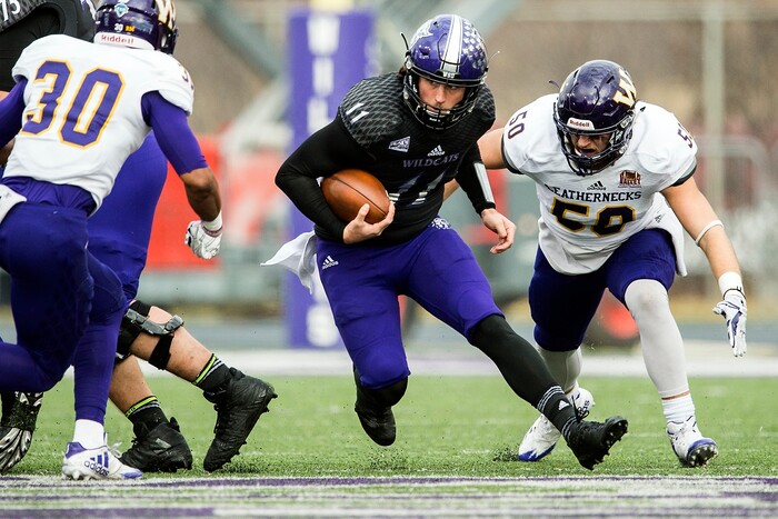 (Chris Detrick  |  The Salt Lake Tribune)  Weber State Wildcats quarterback Stefan Cantwell (11) runs past Western Illinois Leathernecks defensive back Justin Fitzpatrick (30) and Western Illinois Leathernecks linebacker Pete Swenson (50) during the game at Stewart Stadium Saturday, November 25, 2017.  