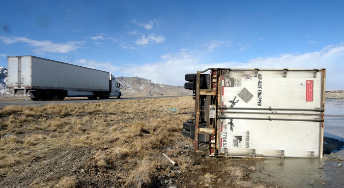 (Al Hartmann  |  The Salt Lake Tribune) 	One of three semi truck trailers that flipped over on I-80  westbound in high winds around 8:00 a.m. Friday March 2.  The incidents happened between mile posts 79 to 82 just east of the Rowley-Dugway exit in Tooele County.   Wrecking crews were kept busy all morning righting the rigs. 