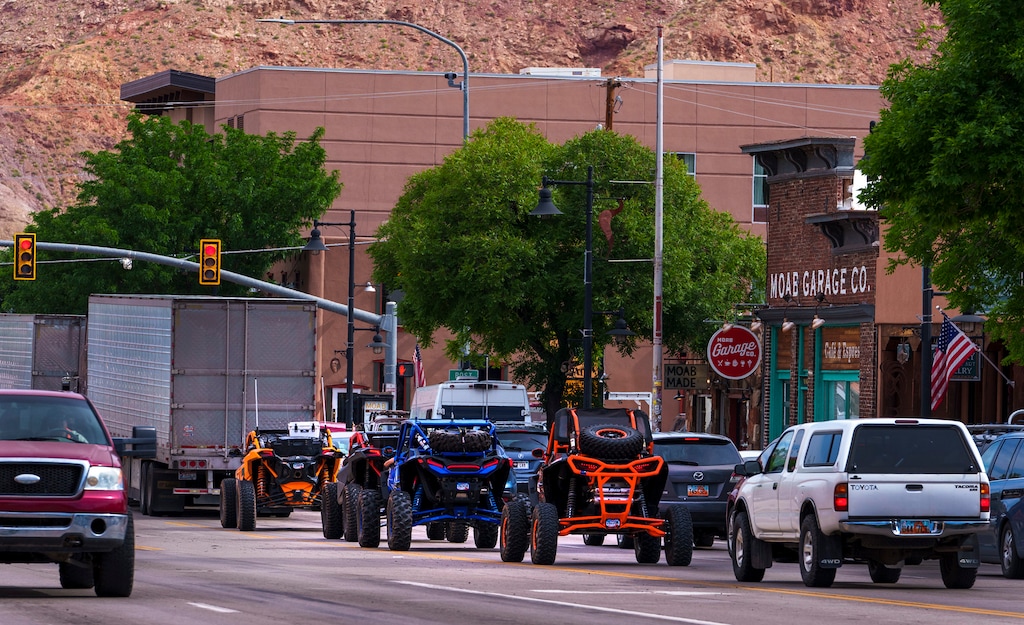 (Leah Hogsten | The Salt Lake Tribune)  Off-road utility terrain vehicles (UTVs) motor down Main Street in Moab, Wednesday, May 17, 2023.