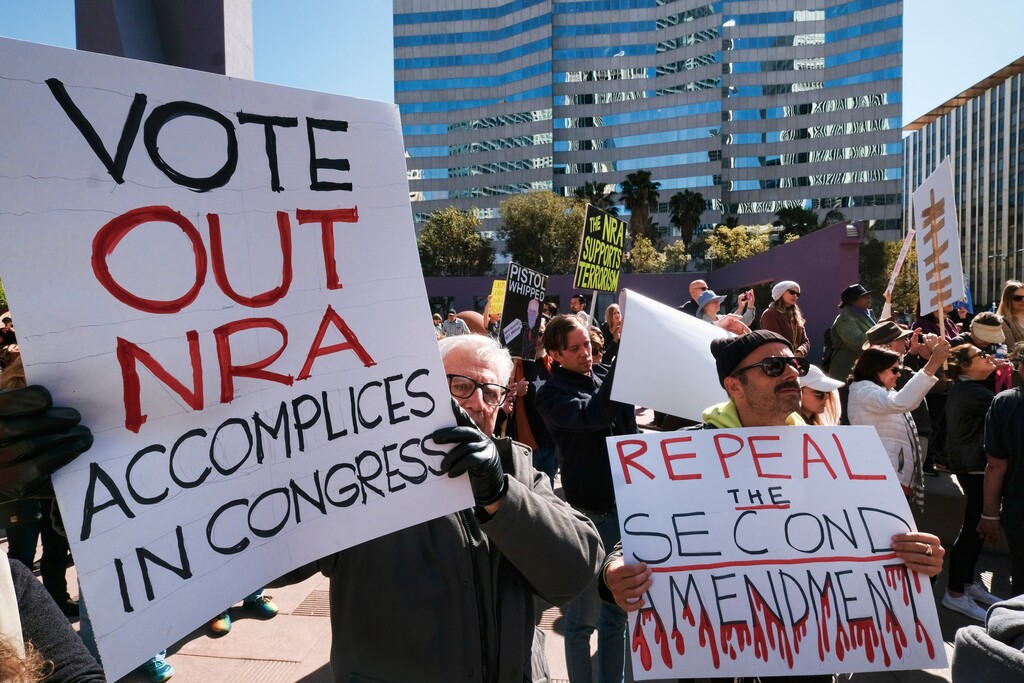 Protesters join in on a grassroots movement during a rally against gun violence in downtown Los Angeles on Monday, Feb. 19, 2018. Hundreds of sign-carrying, chanting protesters have converged on a downtown Los Angeles park, demanding tougher background checks and other gun-safety measures following the deadly school shooting in Florida. (AP Photo/Richard Vogel)