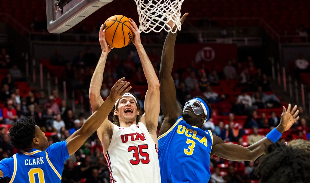 (Rick Egan | The Salt Lake Tribune)  Utah Utes center Branden Carlson (35) goes to the hoop, as UCLA guard Jaylen Clark (0) forward Adem Bona (3) defend for the Bruins at the Jon M. Huntsman Center on Feb. 23, 2022.