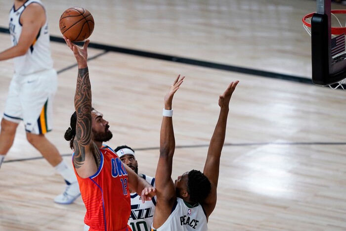 Oklahoma City Thunder's Steven Adams (12) shoots over Utah Jazz's Tony Bradley (13) during the first half of an NBA basketball game Saturday, Aug. 1, 2020, in Lake Buena Vista, Fla. (AP Photo/Ashley Landis, Pool)