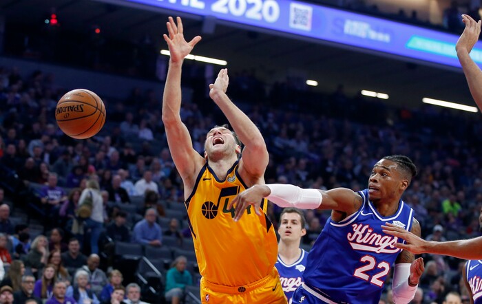 Utah Jazz forward Bojan Bogdanovic, left, is fouled by Sacramento Kings forward Richaun Holmes during the first quarter of an NBA basketball game in Sacramento, Calif., Friday, Nov. 1, 2019. (AP Photo/Rich Pedroncelli)