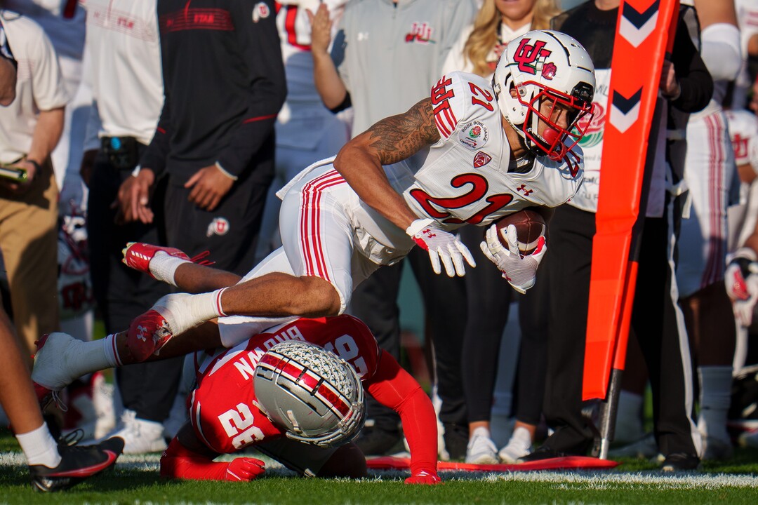 (Trent Nelson  |  The Salt Lake Tribune) Utah Utes wide receiver Solomon Enis (21) dives for a first down as the Utah Utes face the Ohio State Buckeyes at the Rose Bowl in Pasadena, Calif., on Saturday, Jan. 1, 2022.