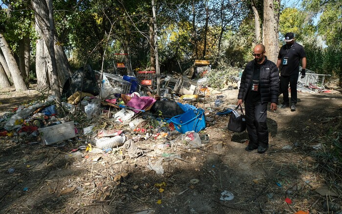 (Francisco Kjolseth  |  The Salt Lake Tribune)  Patrick Rezac, left, Executive Director of One Voice Recovery and Alex Larson visit a transient camp along the Jordan River to offer support only to find the camp had been recently dismantled. In an effort to curb the incidents of hepatitis C, HIV and STD's, the grass roots team hands out disease prevention kits and provides a needle exchange program.