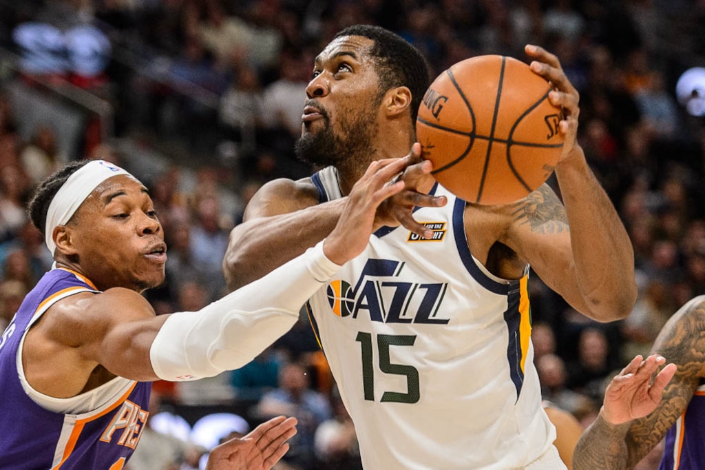 (Trent Nelson | The Salt Lake Tribune)  Utah Jazz forward Derrick Favors (15) drives on Phoenix Suns forward Richaun Holmes (21) as the Utah Jazz host the Phoenix Suns, NBA basketball in Salt Lake City on Monday March 25, 2019.