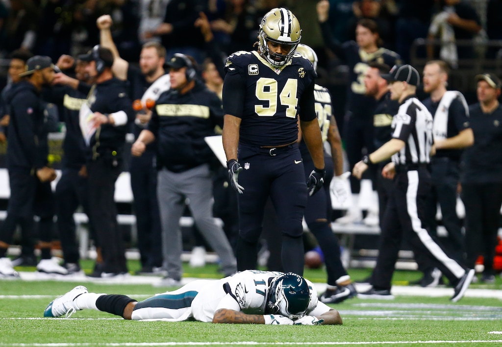 Philadelphia Eagles wide receiver Alshon Jeffery (17) lies on the turf in front of New Orleans Saints defensive end Cameron Jordan (94) after the Saints intercepted a pass in the second half of an NFL divisional playoff football game in New Orleans, Sunday, Jan. 13, 2019. The Saints won 20-14. (AP Photo/Butch Dill)