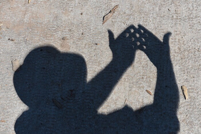 (Francisco Kjolseth  |  The Salt Lake Tribune)  Small highlights between crossed fingers reveal the crescent shape of the sun as the moon begins to completely eclipse the sun on Monday, August 21, 2017.
