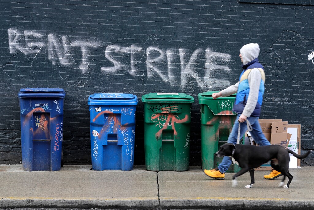 (Ted S. Warren | AP file photo)

In this April 1 photo, a pedestrian walks past graffiti that reads "Rent Strike" in Seattle's Capitol Hill neighborhood. The White House announced Tuesday, Sept. 1, that the Centers for Disease Control and Prevention would act under its broad powers to prevent the spread of the coronavirus. The measure would forbid landlords from evicting anyone for failure to pay rent, providing the renter meets criteria.
