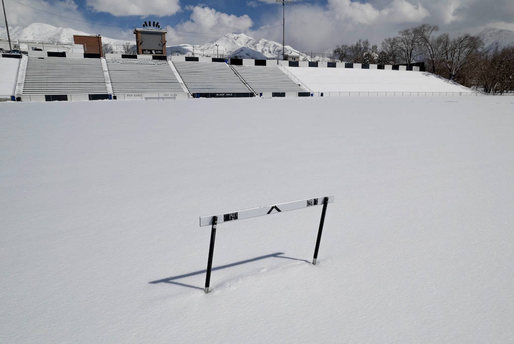 (Francisco Kjolseth | The Salt Lake Tribune) A solitary track hurdle is surrounded in a layer of snow at Highland High School on Wednesday, April 5, 2023. The snow has impacted spring sports a ton. Canceled games, logistical scheduling nightmares or finding unique solutions to get the snow out.