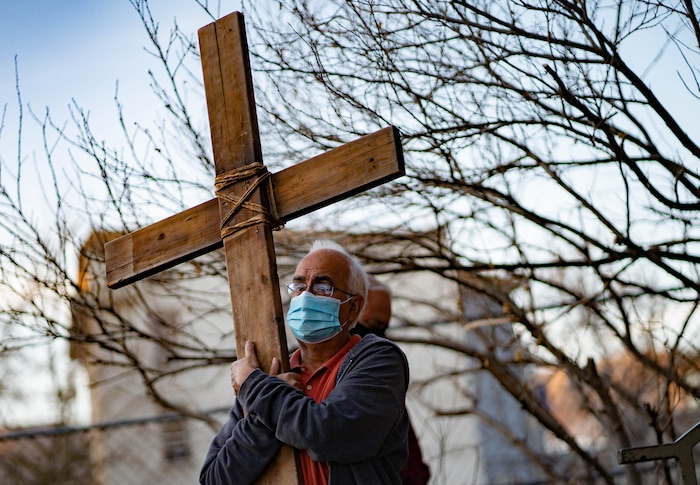 (Francisco Kjolseth | The Salt Lake Tribune) Anthony Estrada joins other christians in their annual interfaith Procession of the Cross through downtown Salt Lake City on Good Friday, to symbolically mark Jesus' carrying the cross to his crucifixion, April 2, 2021, as they stop at Crossroads Food Pantry along the way.
