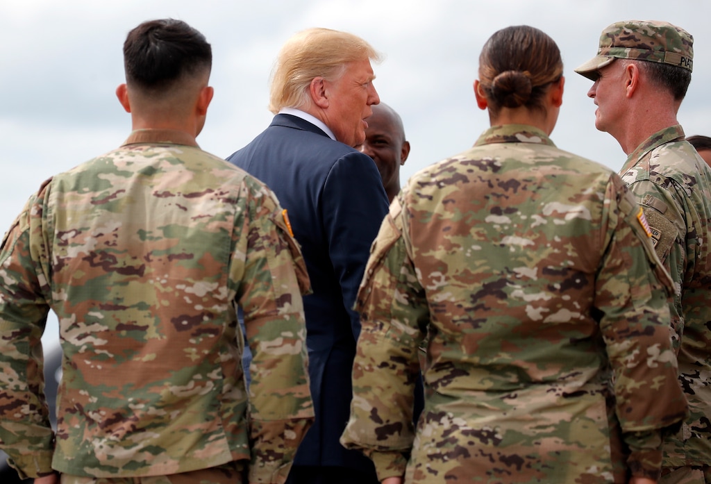 President Donald Trump greets member of the military as he arrives on Air Force One at Wheeler-Sack Army Air Field in Fort Drum, N.Y., Monday, Aug. 13, 2018. (AP Photo/Carolyn Kaster)