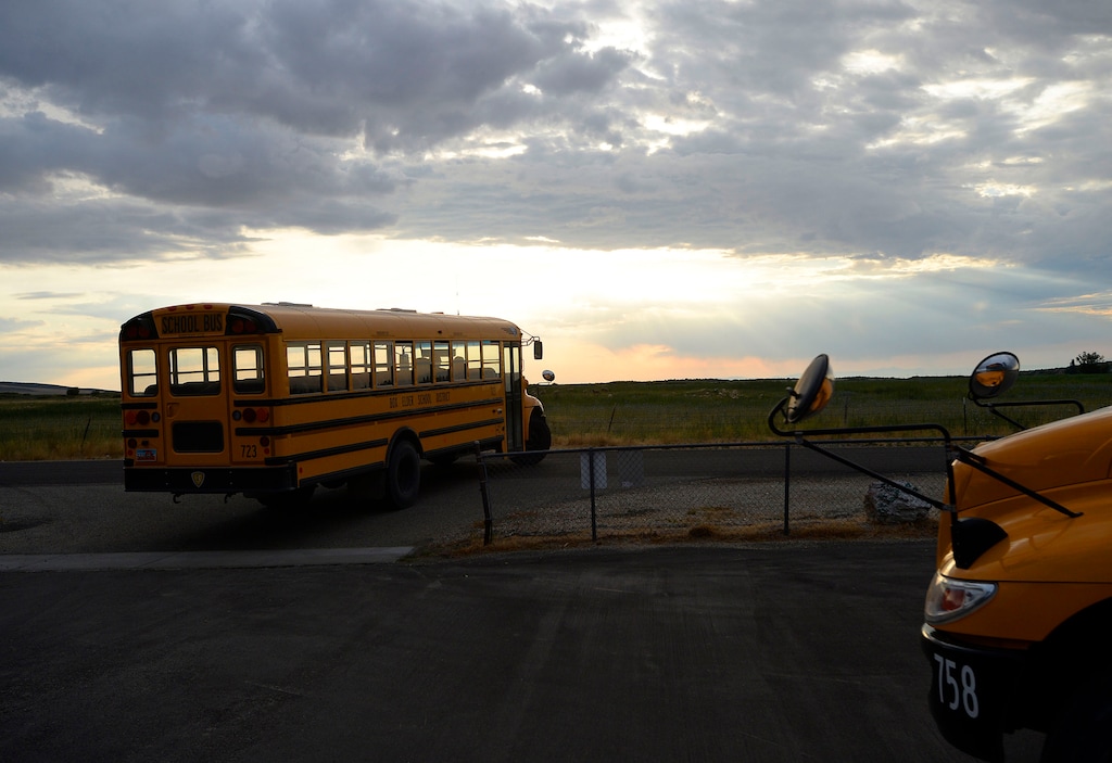 (Al Hartmann  |  The Salt Lake Tribune) Two school buses drop off students at Park Valley School.