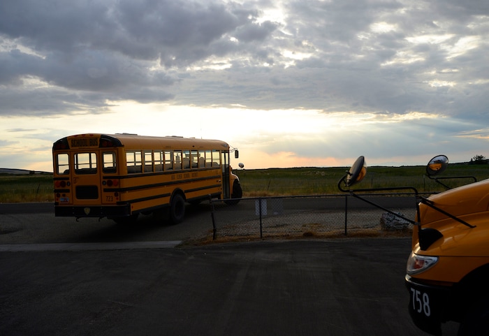 (Al Hartmann | The Salt Lake Tribune) Two school buses drop off students at Park Valley School early morning Wednesday August 30. First bus pickup is at 7 a.m. to deliver students to class in time for first bell at 7:40 a.m. four days a week.