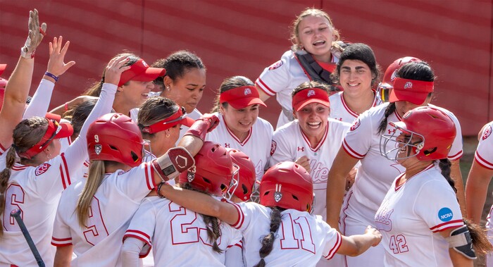 (Rick Egan | The Salt Lake Tribune)  The Utes greetJulia Jimenez as she crosses home plate, after hitting a grand slam home run, giving Utah a 7-1 lead, in NCAA Softball Super Regionals action between the Utah Utes and the San Diego State Aztecs, on Saturday, May 27, 2023.
