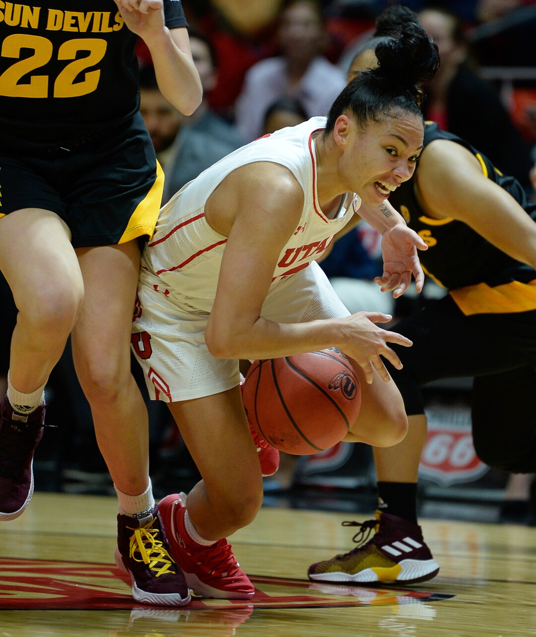 (Francisco Kjolseth  |  The Salt Lake Tribune) Utah Utes guard Kiana Moore (0) gets tripped up by the Arizona State Sun Devils in Utes' Pac-12 home opener at the Jon M Huntsman Center on Friday, Jan. 4, 2019. 