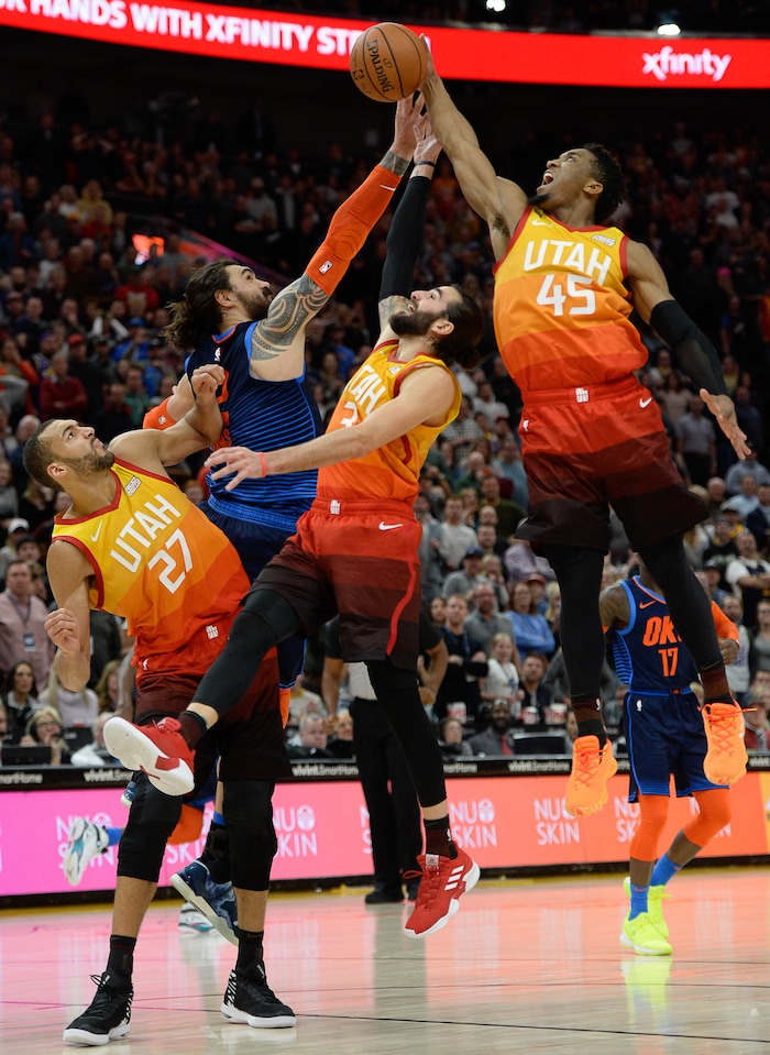 (Francisco Kjolseth  |  The Salt Lake Tribune)   Utah Jazz guard Donovan Mitchell (45) gains control of a rebound in the final seconds of the game as Utah Jazz center Rudy Gobert (27) and Utah Jazz guard Ricky Rubio (3) try to assist with Oklahoma City Thunder center Steven Adams (12) putting on the pressure in the second half of the NBA game at Vivint Smart Home Arena Sat., Dec. 22, 2018, in Salt Lake City.