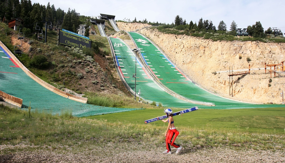 Steve Griffin | The Salt Lake TribuneWith her huge skis over her shoulder USA ski jumper Sarah Hendrickson walks to the chair lift at the Utah Olympic Park in Park City, Utah Monday July 29, 2013.