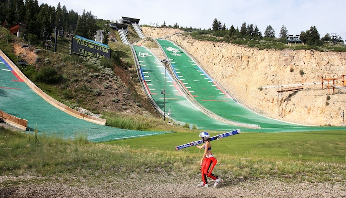 Steve Griffin | The Salt Lake Tribune

With her huge skis over her shoulder USA ski jumper Sarah Hendrickson walks to the chair lift at the Utah Olympic Park in Park City, Utah Monday July 29, 2013.