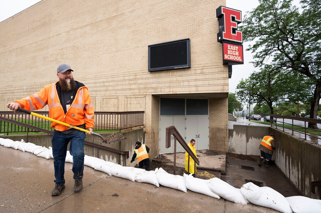 (Rick Egan | The Salt Lake Tribune) Workers clear mud and debris from the stairs leading to the gymnasium at East High School, on Monday, Aug. 2, 2021.