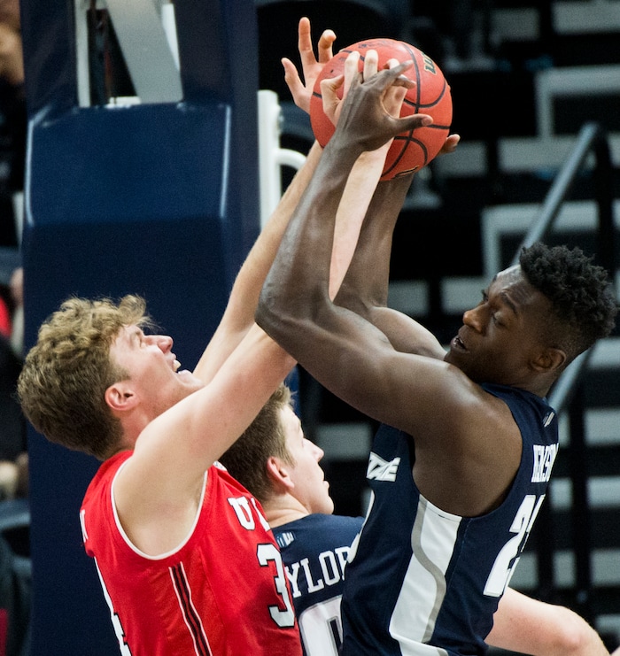 (Rick Egan  |  The Salt Lake Tribune)  Utah Utes forward Jayce Johnson (34) and Utah State Aggies forward Daron Henson (23) go for a loose ball, in Beehive Classic basketball action at the Vivint SmartHome Arena, Saturday, December 9, 2017.