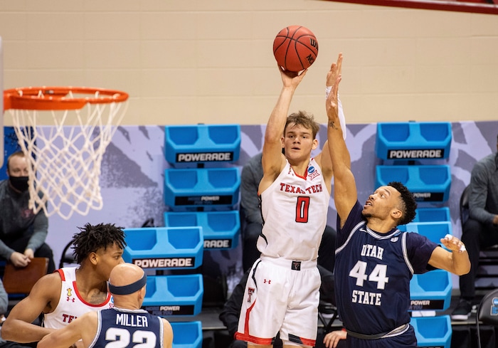 (Doug McSchooler | AP) Texas Tech guard Mac McClung (0) shoots a 3-point shot while Utah State guard Marco Anthony (44) defends during the second half of a first round game in the NCAA men's college basketball tournament, Friday, March 19, 2021, at Assembly Hall in Bloomington, Ind.