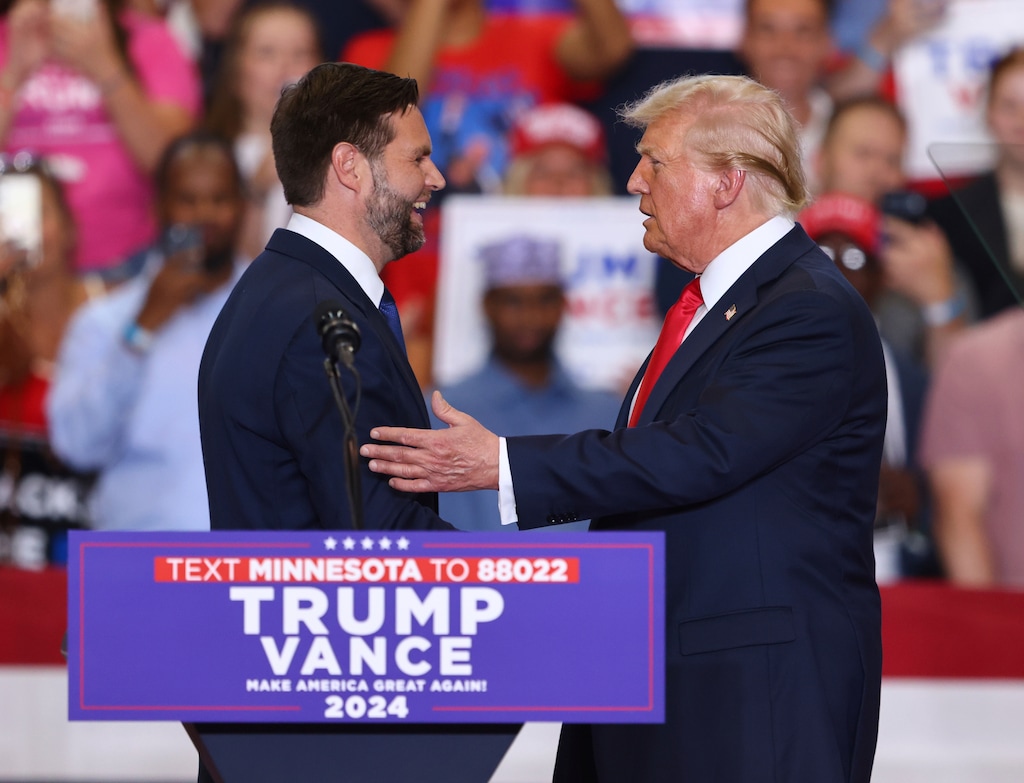 (Adam Bettcher | AP) Republican presidential candidate former President Donald Trump and Republican vice presidential candidate Sen. JD Vance, R-Ohio, greet each other at a campaign rally, Saturday, July 27, 2024, in St. Cloud, Minn.