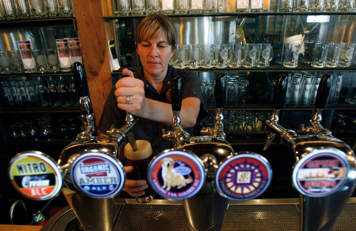 (Francisco Kjolseth  | Tribune file photo) Jenny Talley, SLC's award-winning brewmaster at Squatters, fills up a glass of Organic Amber Ale in an environment she has become deeply familiar with over the past 20 years. Talley is one of the few female brewers in the U.S., working a tough physical job.