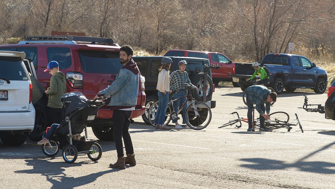 (Leah Hogsten  |  The Salt Lake Tribune) Families and friends congregate around their cars in the Rainbow Gardens gift shop and restaurant parking lot in Ogden on Sunday after hikes and bike rides in the foothills and the nearby Ogden River Trail. As the global battle against COVID-19 deepens, some Utahns have used the stateÕs great outdoors as an alternative to isolating at home. March 22, 2020 in Ogden.