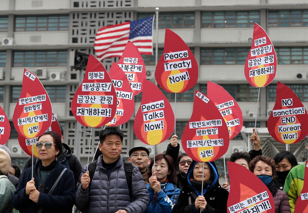 (AP Photo/Lee Jin-man) Protesters hold signs during a rally demanding the denuclearization of the Korean Peninsula and peace treaty near the U.S. embassy in Seoul, South Korea, Thursday, March 21, 2019. The Korean Peninsula remains in a technical state of war because the 1950-53 Korean War ended with an armistice, not a peace treaty. More than 20 protesters participated at a rally and also demanding the end the Korean War and to stop the sanction on North Korea. The letters read "Restarting operations at Kaesong industrial complex and Diamond Mountain resort."
