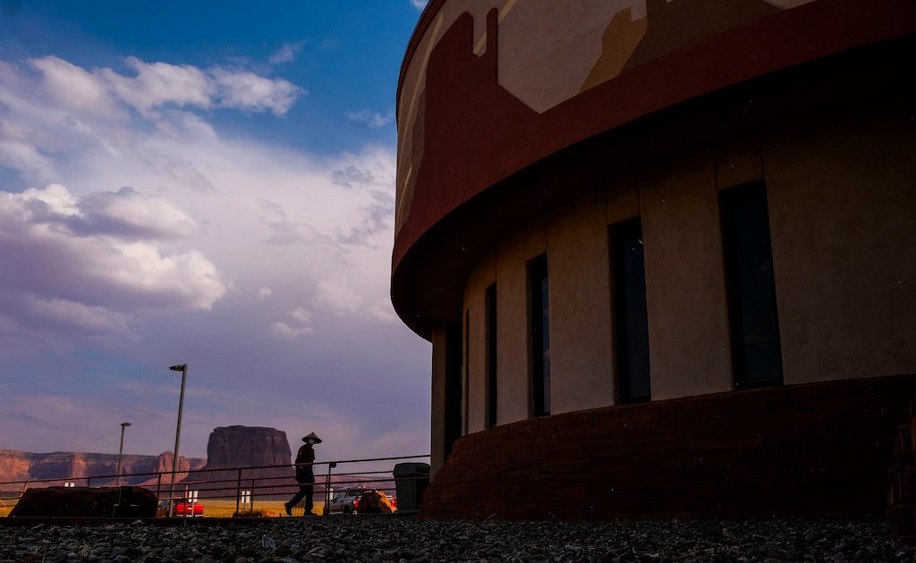 (Leah Hogsten  |  The Salt Lake Tribune)  Monument Valley Health Clinic pharmacy runner Delbert Dixon, above in red, hustles in and out of the building, delivering medications to patients sitting in their cars Aug., 24, 2020. 